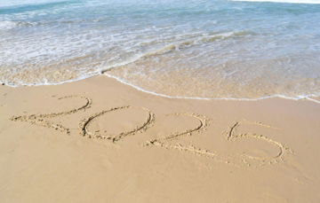 A sandy beach with the word summer written in the sand